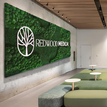 Redwood Medical seamless moss wall with corporate logo in modern healthcare waiting area