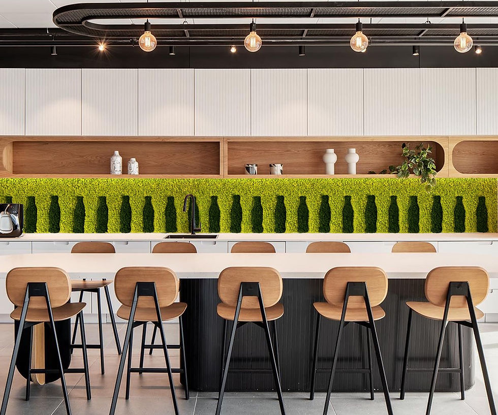 Custom patterned moss backsplash using bright yellow-green reindeer moss with dark bottle silhouettes in a modern office kitchen