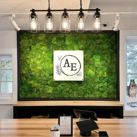 Lush greenery Mood Moss Wall showing client's customized logo