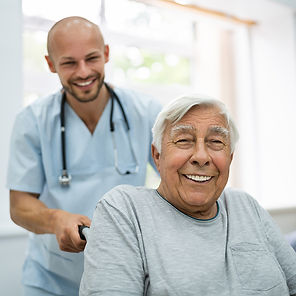 health care working pushing the wheelchair of a patient with a chronic wound