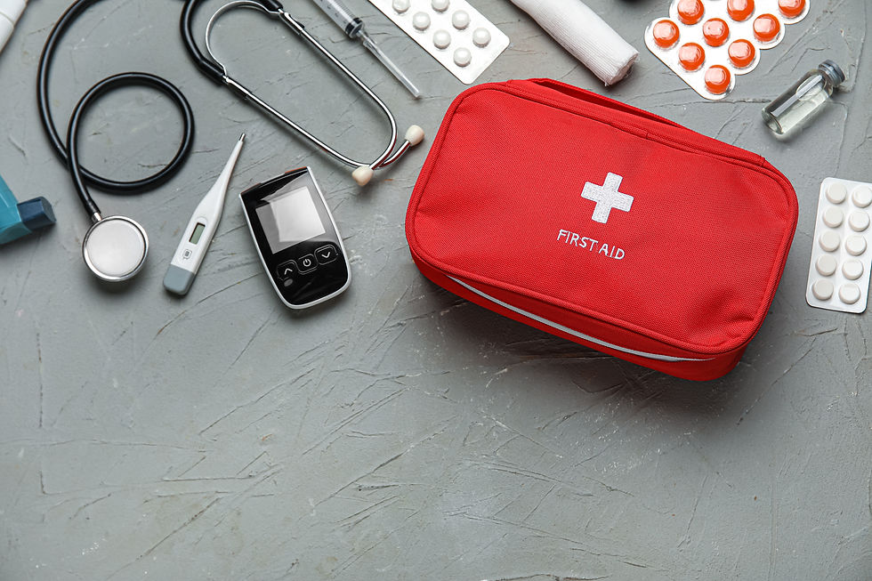 First aid kit and pills on grey background.jpg