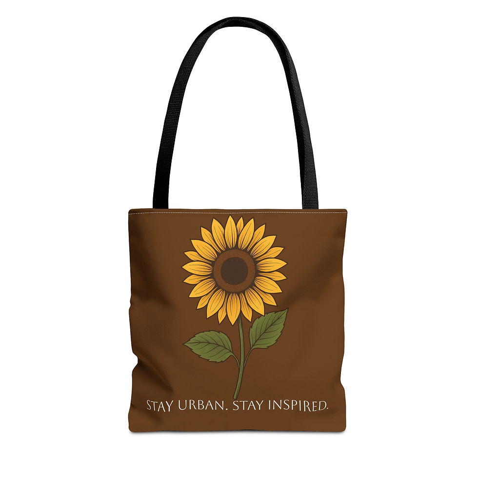 “Black reusable tote bag with a bright sunflower illustration and the text ‘Stay Urban. Stay Inspired.’ displayed in a cozy h
