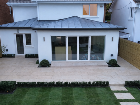 The zinc roof sits above a clean patio layout, creating a modern and functional outdoor area.