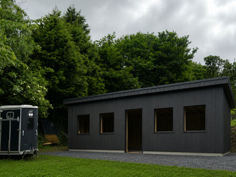 Front view of modern garden room with Vestis graphite black standing seam aluminium roof in Kilakee, Dublin.