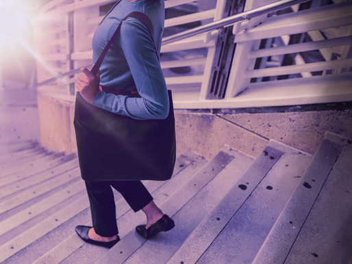 A woman walking down the stairs and leaving behind a toxic relationship. darkness is behind her and light is in front of her