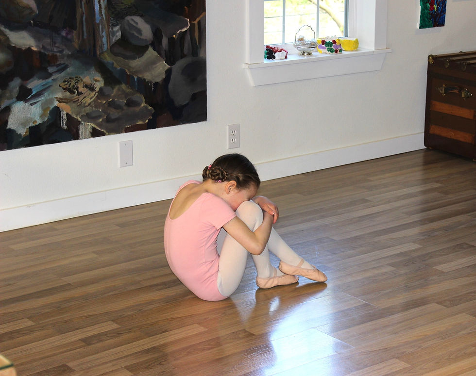 Little girl in pink leotard, tights and ballet shoes with hair in braided bun. In living room doing ballet class over zoom during covid restrictions in 2020. Painting in background by Etienne Zack.