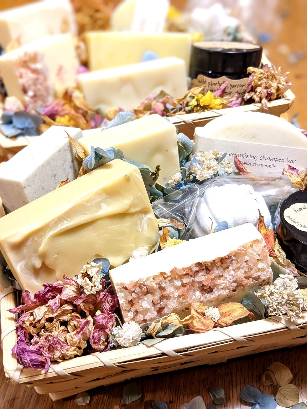 Natural bamboo gift basket filled with dried flowers, salt soap, poplar bud soap, shampoo bars, warm weather bar, and regenerating night cream by slow botanicals.