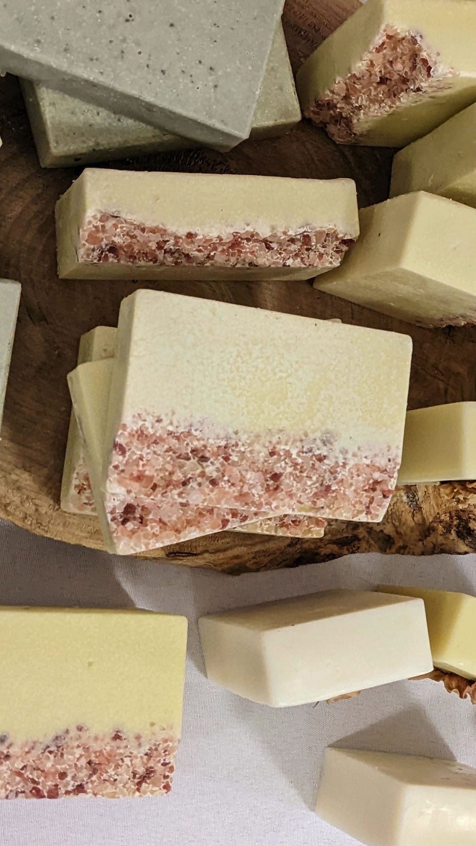 Thumbnail: Stacks of handmade soap at market including organic pink salt hand soap