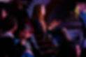 Gala in a seat smiling and clapping