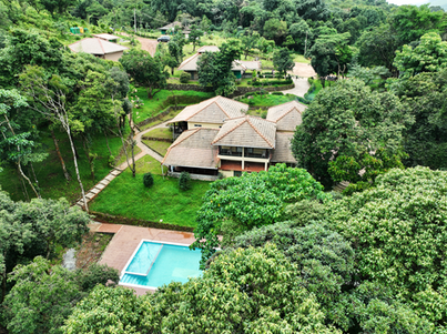 Aerial view of Kallumetlu Resort cottages nestled in the Sakleshpur Western Ghats valley.png