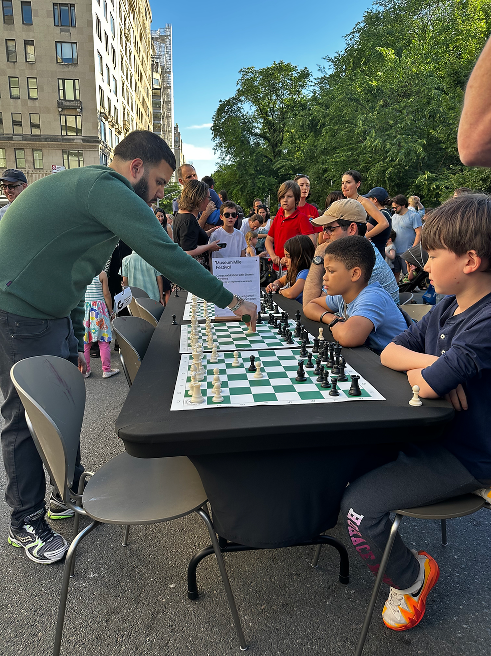 Students participating in a Pushing Pawns chess lesson, learning strategy, problem solving, and teamwork in an engaging class