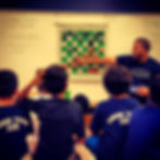 Students participating in a Pushing Pawns school chess lesson with National Master Shawn Martinez in an engaging classroom en