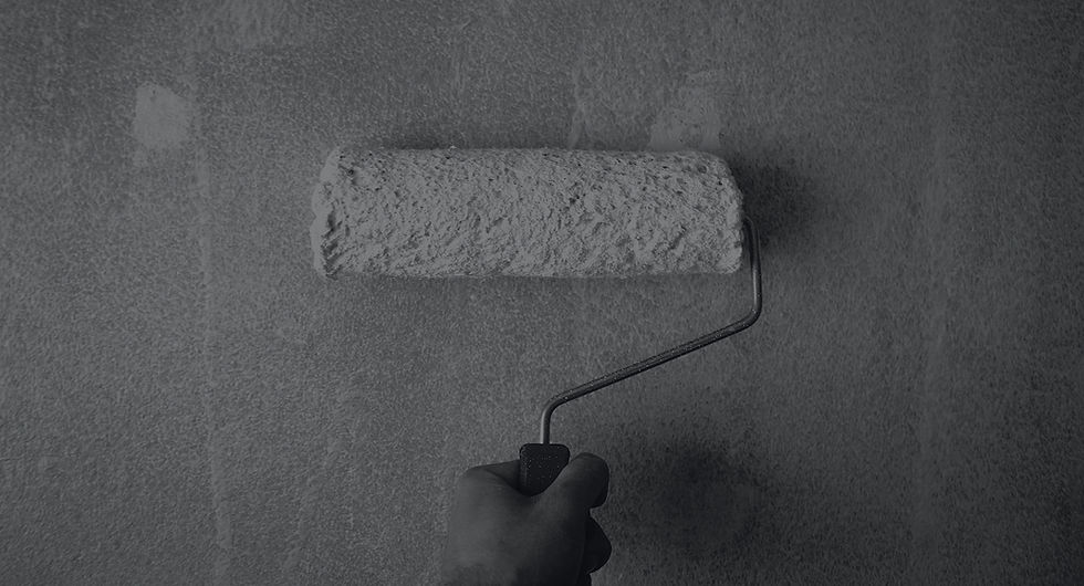 person-holding-paint-roller-on-wall-1669