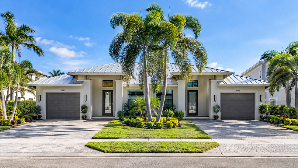 Modern residential property with palm trees and two garages.