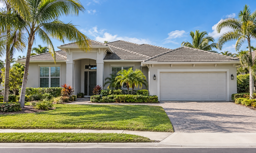 Modern tropical rental home with palm trees and lawn.
