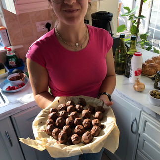 Emma proudly holding a plate of homemade energy balls, after gaining confidence cooking with the Thermomix TM7 in Ireland.