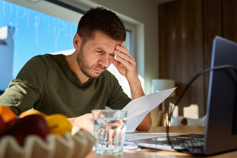 Self-employed borrower reviewing accounts while applying for a mortgage in the UK.