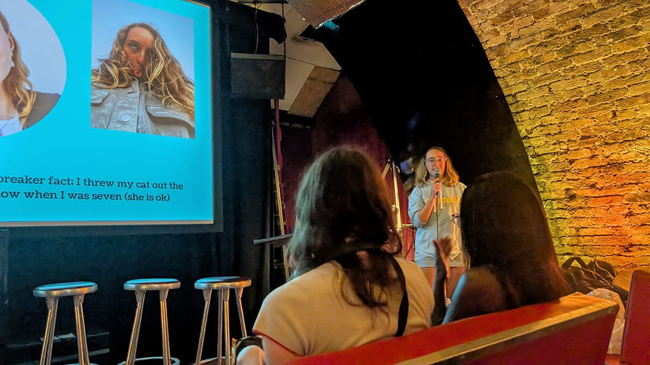 female gen-z speaker delivering a talk on gen-z copywriting to a room of gen-zrs