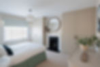 Bespoke wardrobes either side of original fireplace delivering a neutral calm bedroom space