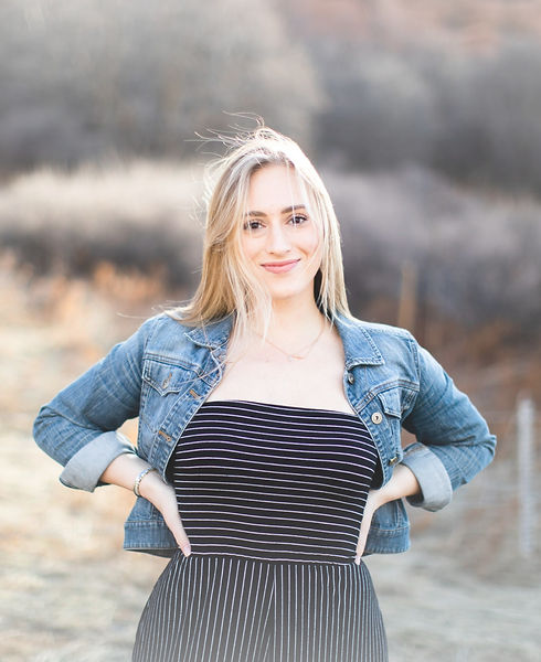 Cassie Little posing outdoors with hands on hips