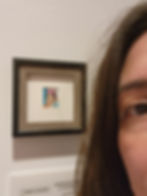 A visitor next to the Frida Kahlo miniature portrait