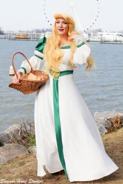 A cosplayer dressed up as Odette in the National Harbor standing in front of the National Wheel
