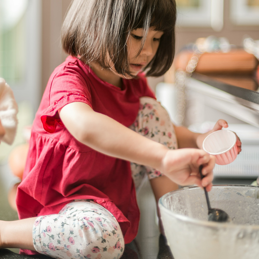 A child cooks while sitting on natural stone granite countertops revived by Stone Revivers in Metairie, Louisiana