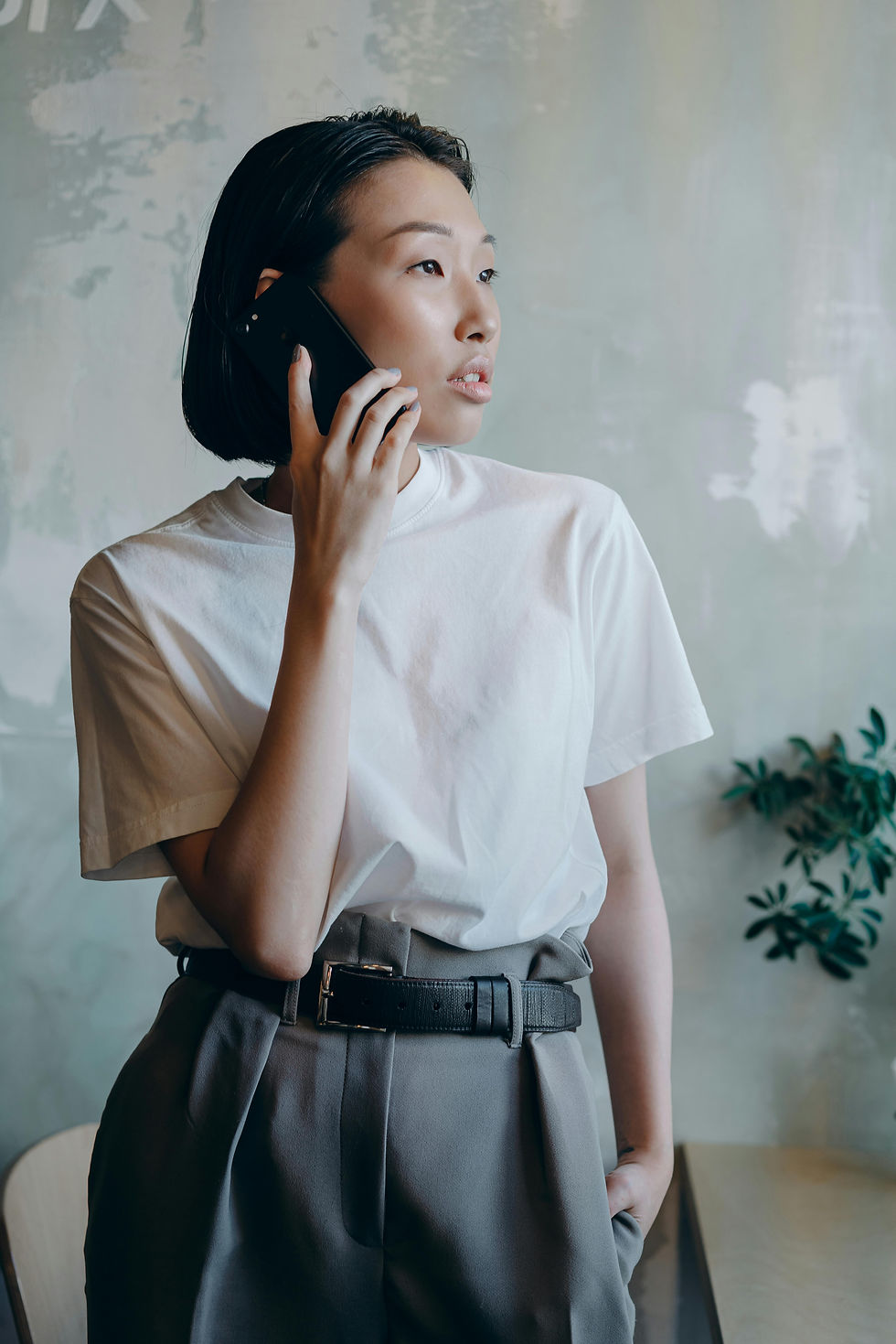 A asian woman on the phone with Stone Revivers scheduling her appointment for Natural Stone restoration, cleaning, and repair.