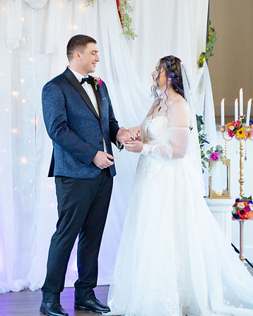 Bride and groom smiling at each other