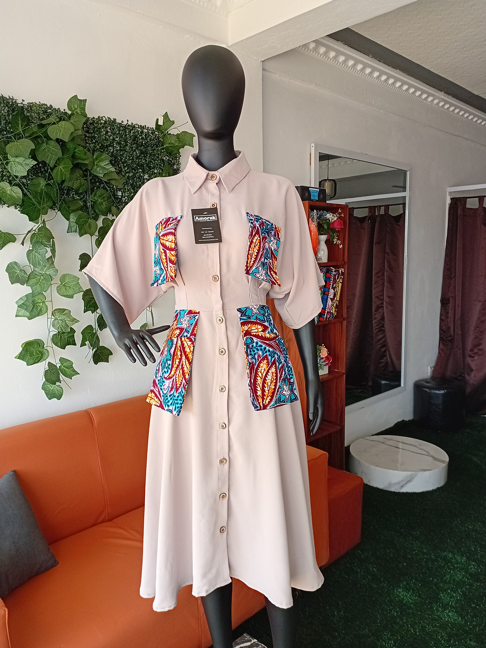 Thumbnail: Plain long button dress with african print hang pockets.