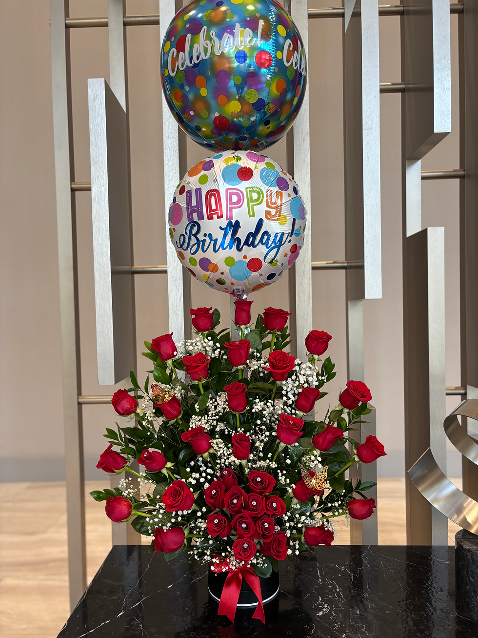 Red roses with Happy Birthday balloon, floral arrangement, and Doral Blooms.