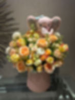 Pink elephant plush toy with a beautiful floral bouquet arrangement Doral Blooms