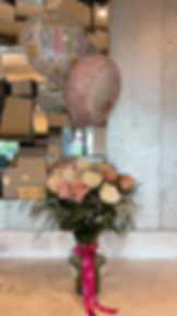 Bouquet of roses under a pink balloon with a box of preserved roses