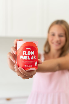Children's product photography featuring a girl holding Voomie Jr wellness supplements in a bright lifestyle setting, photo taken by MNDY Photography
