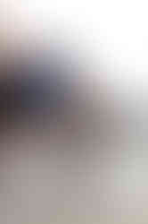 a woman sits on a chair holding a card that says not just your socials team