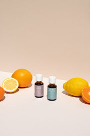 two bottles of pure calm and pure breathe next to oranges and lemons