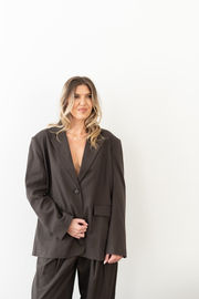 a woman wearing a blazer with a plunging neckline