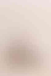 a bag of collagen peptides next to a glass of coffee