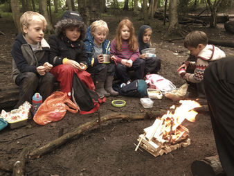 Drinking hot tea during a Muddy Mountains forest school session.