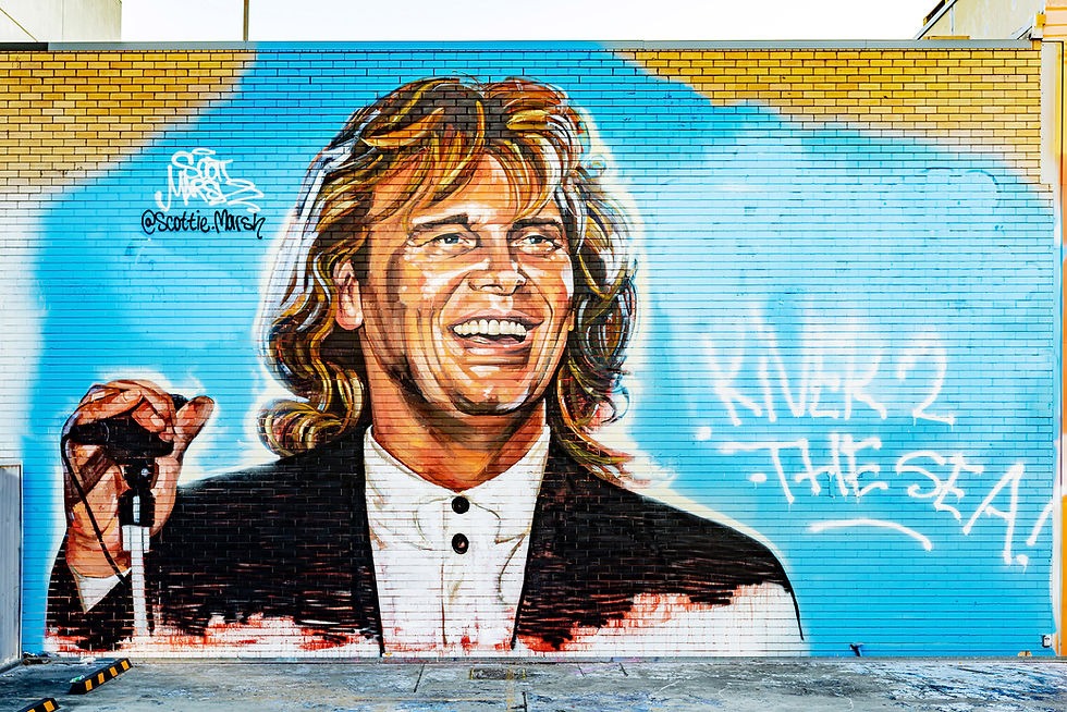 Scott Marsh's John Farnham mural in South Brisbane, with the banned sentence "River to the Sea" repainted after it was censored and covered over. Photo: Alec Smart