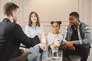 Parents sitting with a mediator to discuss and create a child-focused parenting plan