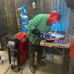 tool tech welding at a table
