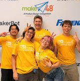 Smarts and Sparks being silly in front of the step and repeat banner