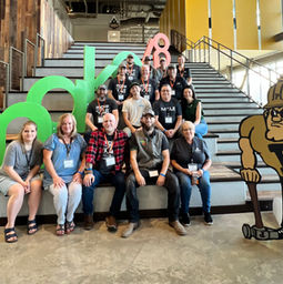 tool tech group photo on stairs with make48 letters on the left side