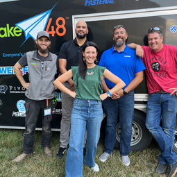 group of 5 volunteers on set up day in front of the tool trailer