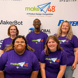 Pipeline Pals standing in front of the step and repeat banner smiling