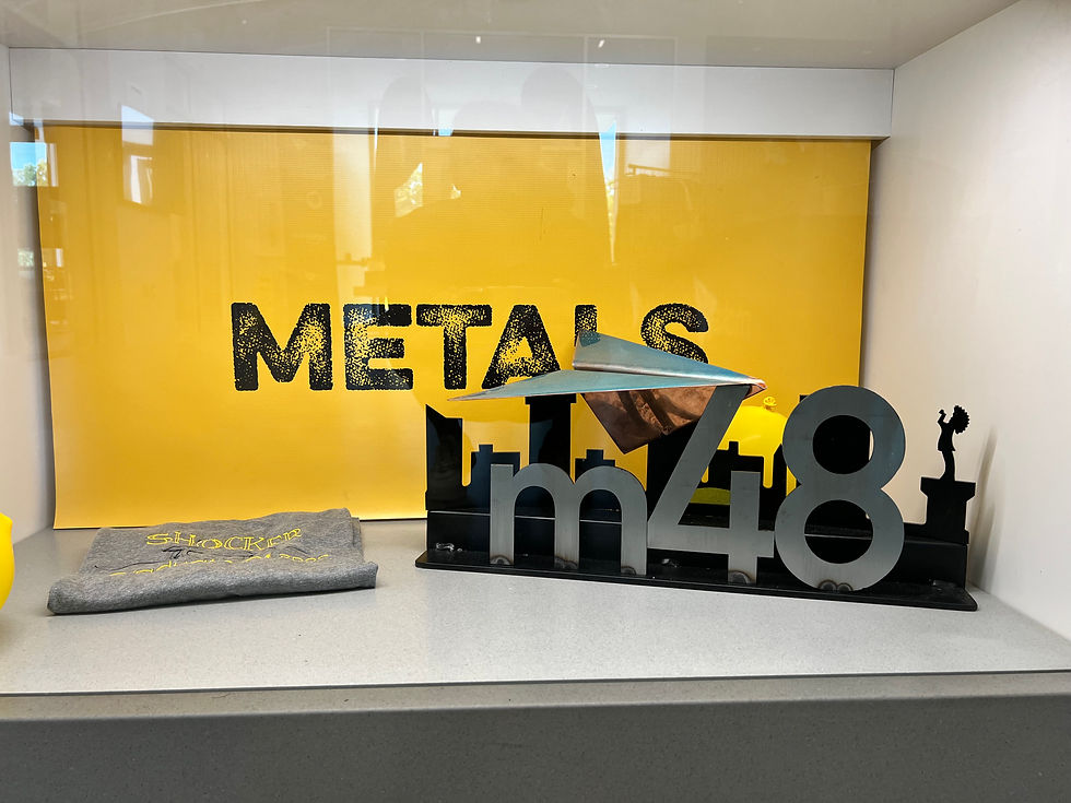 Image of M48 trophy sitting in front of METALS sign at GoCreate makerspace
