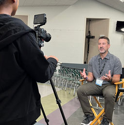 trek employee sitting in a chair being interviewed by a camera