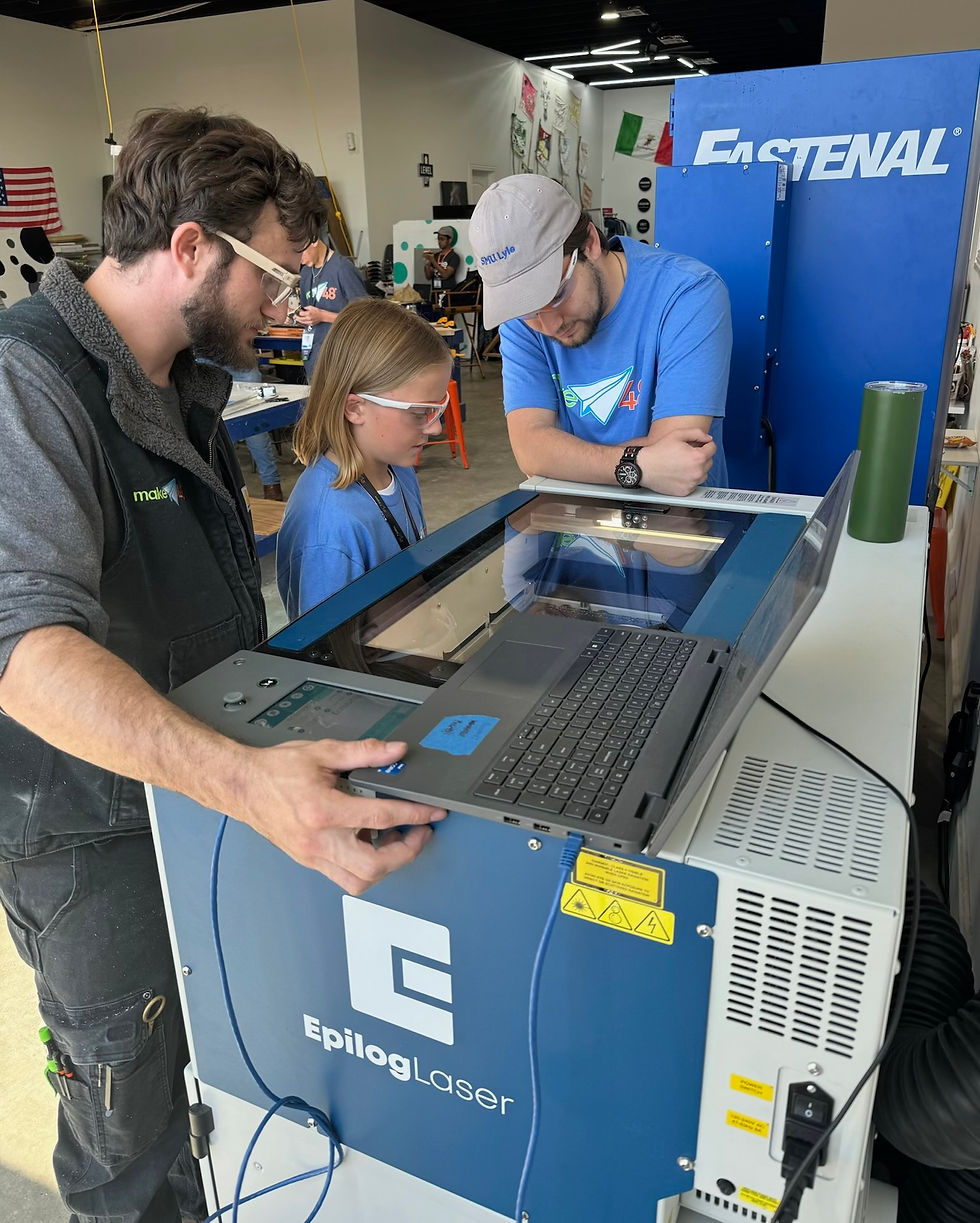 Standing over the Epilog laser machine at Vandermont
