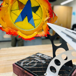 close up photo of the first place trophy that has alliant energy's logo and an airplane